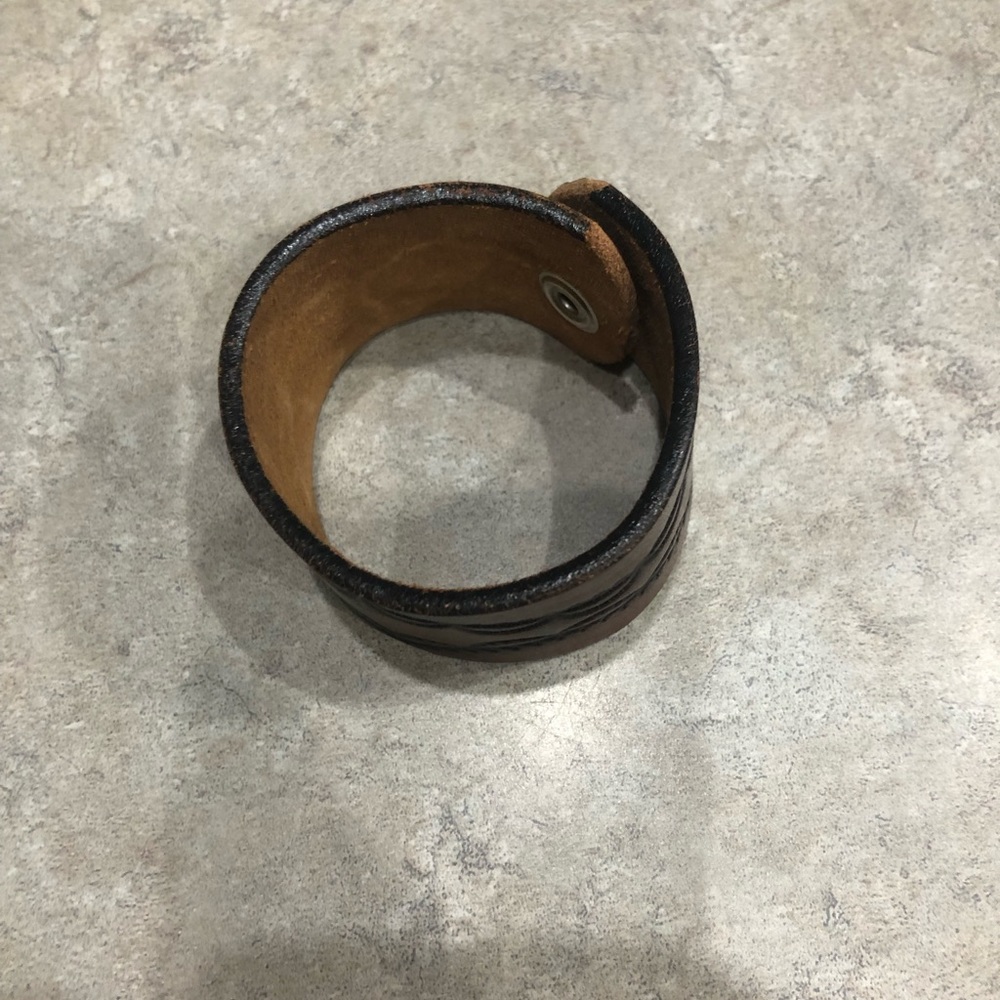 Leather bracelet with snap closure.